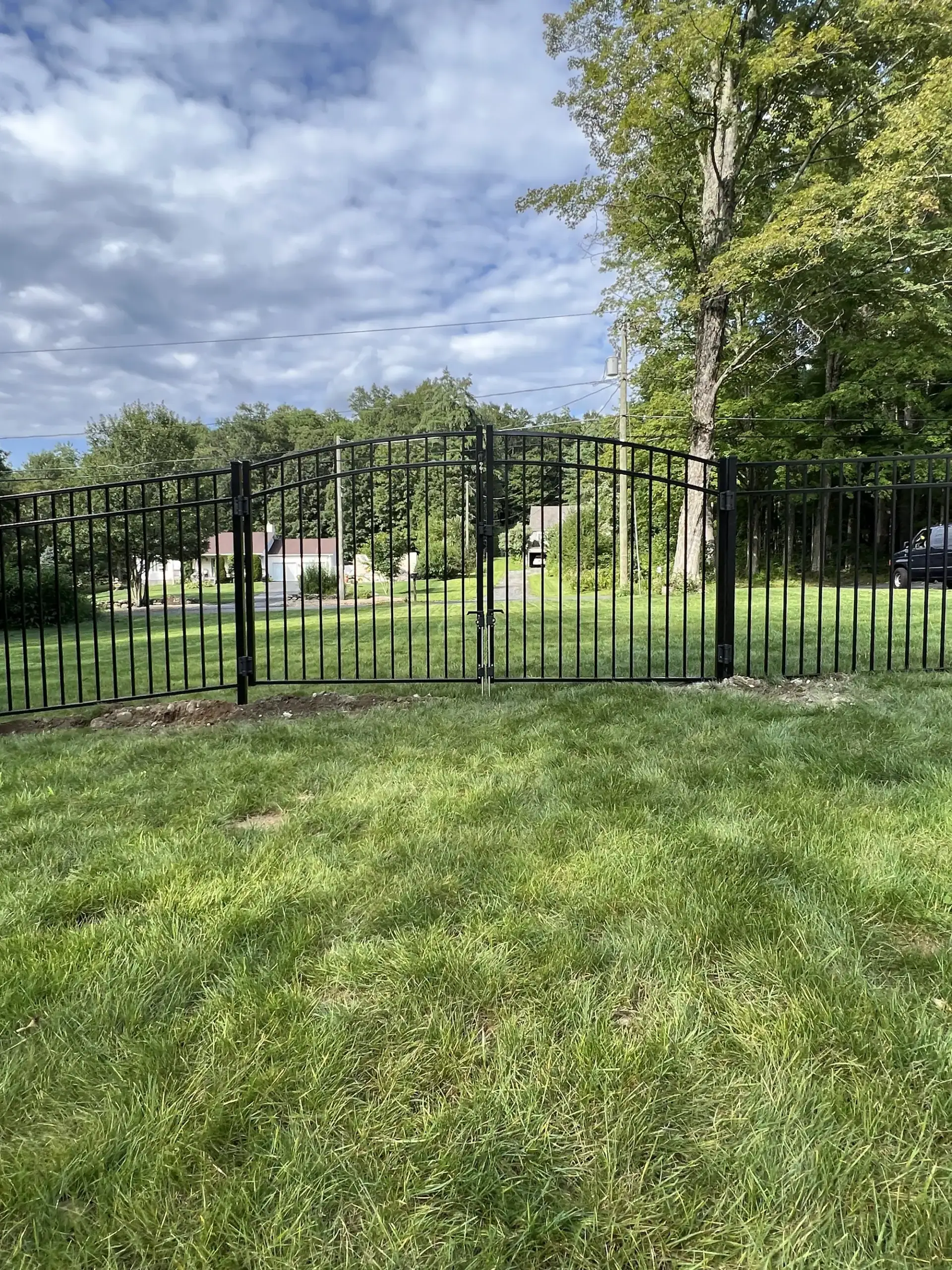 Black aluminum fence with a double arched gate