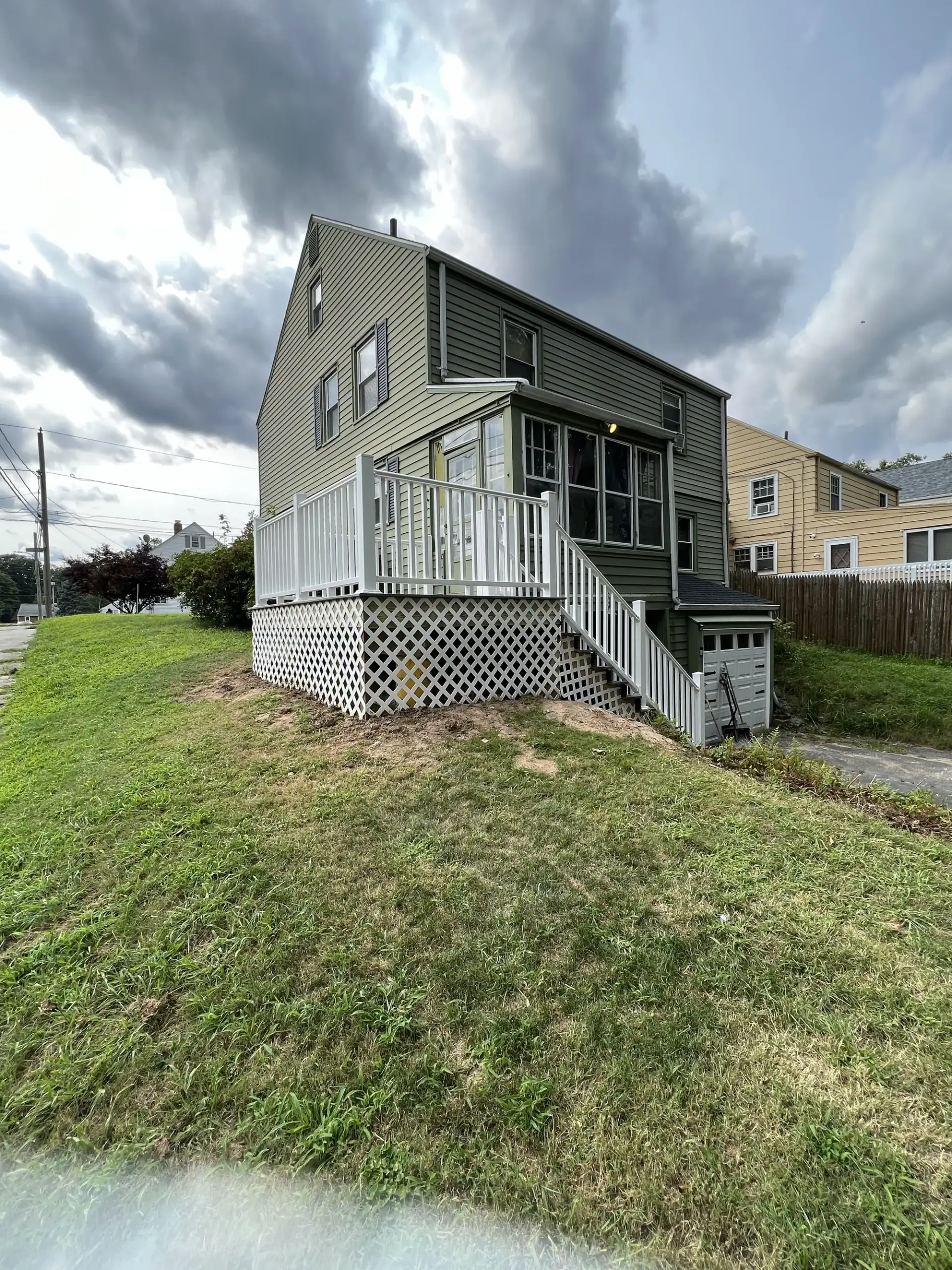 Raised back deck with white vinyl railings and lattice skirting