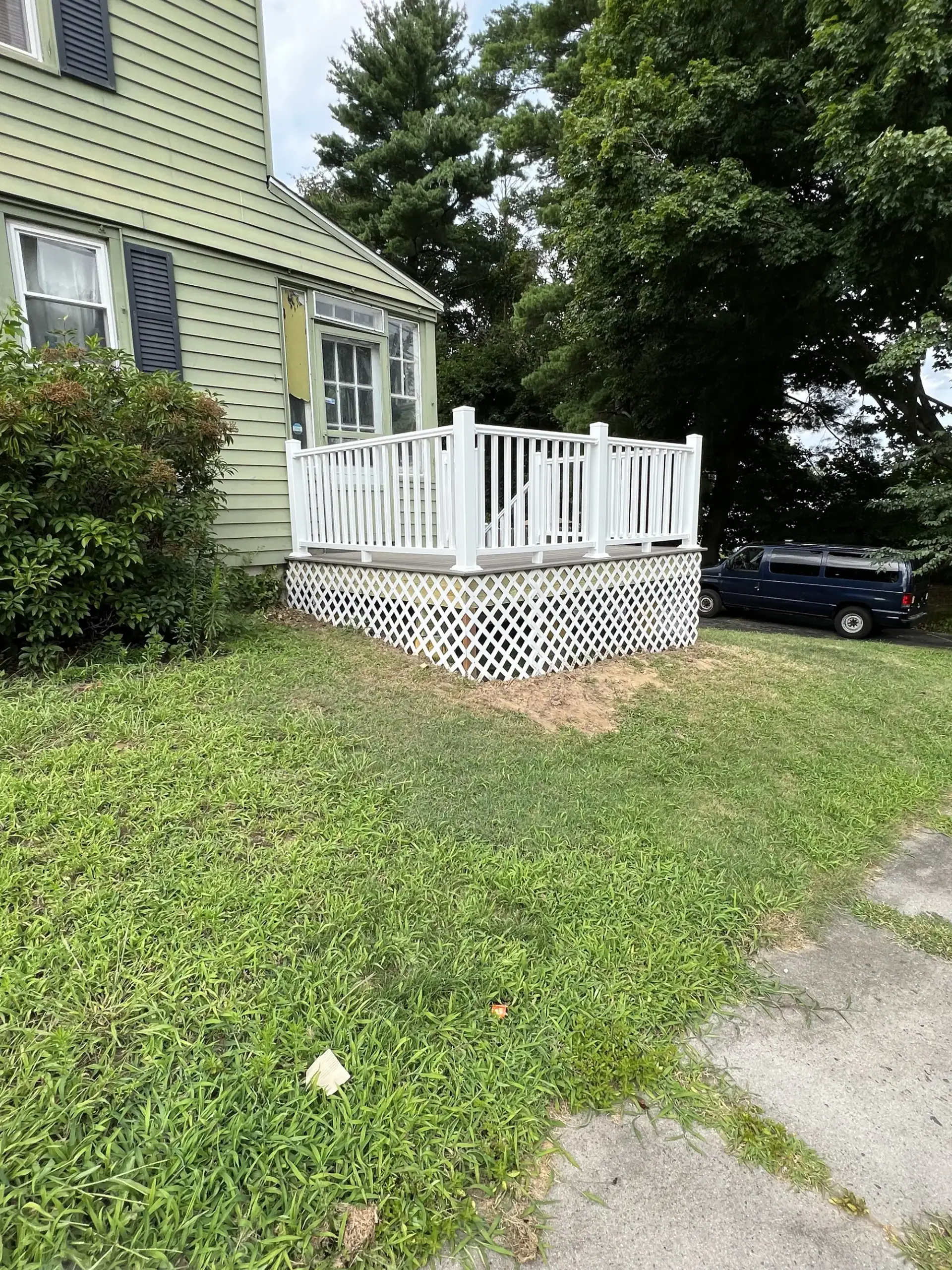 Small porch deck with white vinyl railings